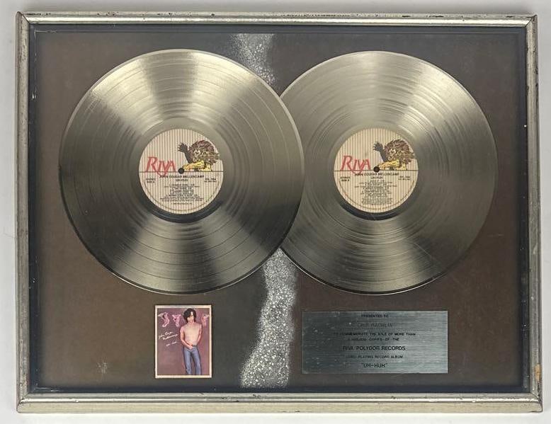 John Cougar Mellencamp "Uh-Huh" RIAA Multi-Platinum Sales Award Presented to Chip Rachlin: RIAA Certified Multi-Platinum Sales Award presented to Chip Rachlin to commemorate the sale of more than 2,000,000 copies of the Riva/Polydor Records album "Uh-Huh" by John Cougar Mellencamp. The