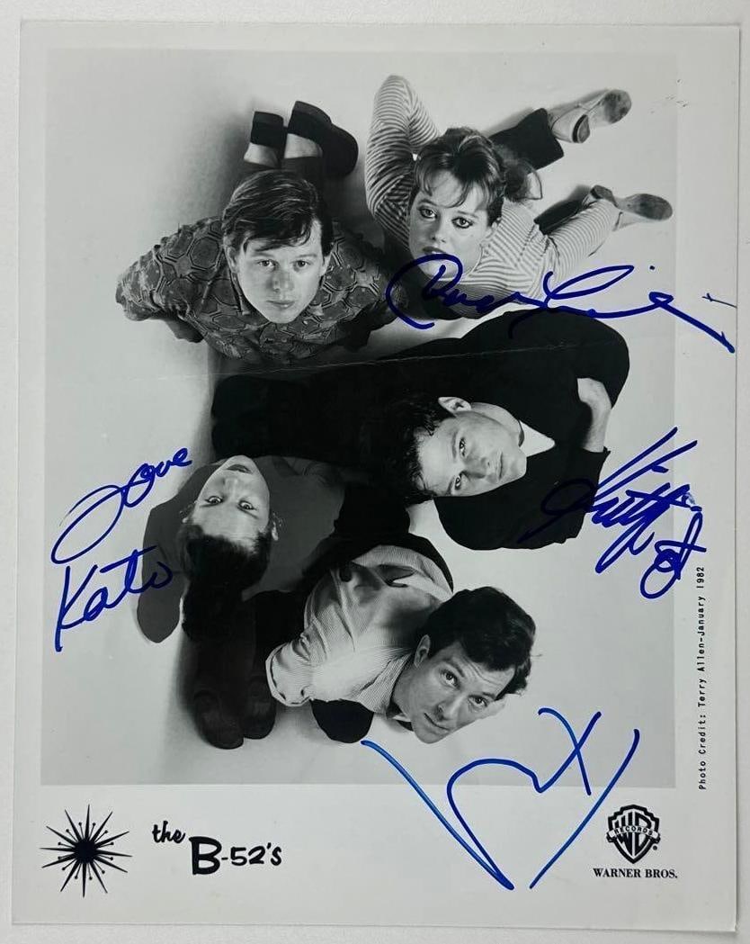 The B-52’s Group Signed 10" x 8" Promo Photo (4 Sigs) (JSA Authentication): Black-and-white 10" x 8" promotional photo signed in blue felt tip marker by The B-52's band members Kate Pierson, who inscribed "love" before her signature, Keith Strickland, Cindy Wilson, and Fred