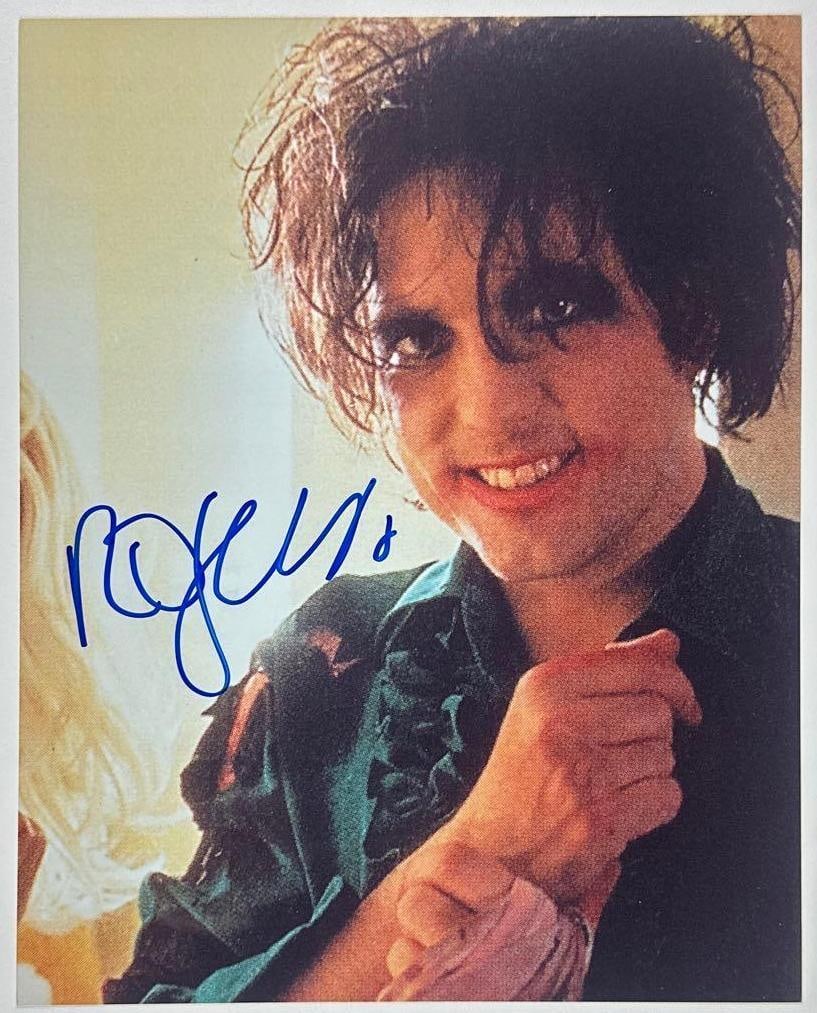 The Cure: Robert Smith Signed 10" x 8" Photo (JSA Authentication): Color 8" x 10" photo signed in blue felt tip marker by The Cure band member Robert Smith. In fine condition. Authenticated by JSA. Provenance This piece was recently authenticated by JSA and may have