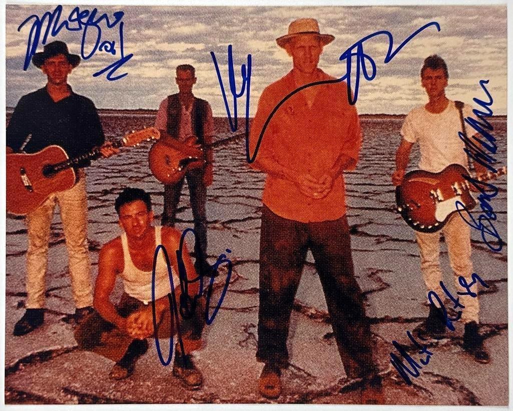 Midnight Oil Group Signed 8" x 10" Photo (5 Sigs) (JSA Authentication): Color 8" x 10" photo signed in blue felt tip marker by Midnight Oil band members Martin Rotsey, Bones Hillman, Jim Moginie, Rob Hirst, and Peter Garrett. In fine condition. Authenticated by JSA.