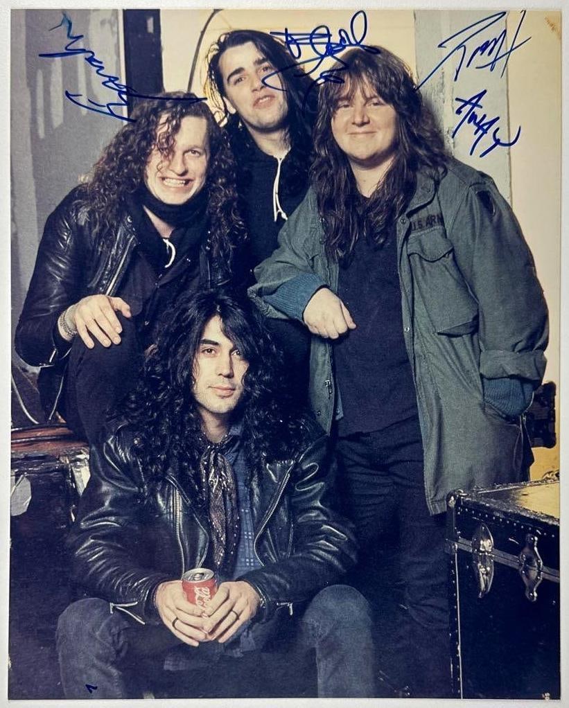 Voivod Group Signed 10" x 8" Photo (4 Sigs) (JSA Authentication): Color 10" x 8" photo signed in blue felt tip marker by Voivod band members Denis Belanger, Denis 'Piggy' D'Amour, Michel 'Away' Langevin, and Jean-Yes 'Blacky' Theriault. In fine condition.