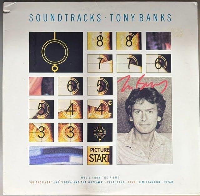 Genesis: Tony Banks Signed "Soundtracks" Album (Third Party Guaranteed): "Soundtracks" album signed in red felt tip marker by musician Tony Banks. This is a promotional copy — back cover marked "Lent for Promotional Use Only, Not for Sale." Measuring approximately 12