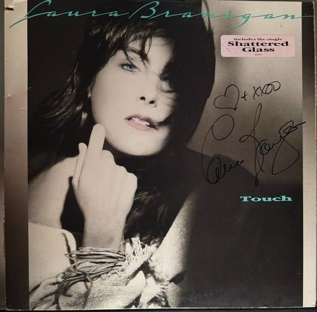 Laura Branigan Signed "Touch" Promo Album (Third Party Guaranteed): "Touch" promotional album signed on the cover in black felt tip marker by musician Laura Branigan, with a heart and "XOXO" inscription. Measuring approximately 12" x 12", the jacket is in good