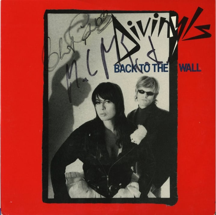 Divinyls Fully Group Signed "Back To The Wall" 45 (ACOA Authentication): "Back To The Wall" 45 picture sleeve signed on the cover in black felt tip marker by Divinyls co-founders Chrissy Amphlett and Mark McEntee. Measuring approximately 7" x 7" and in good condition with