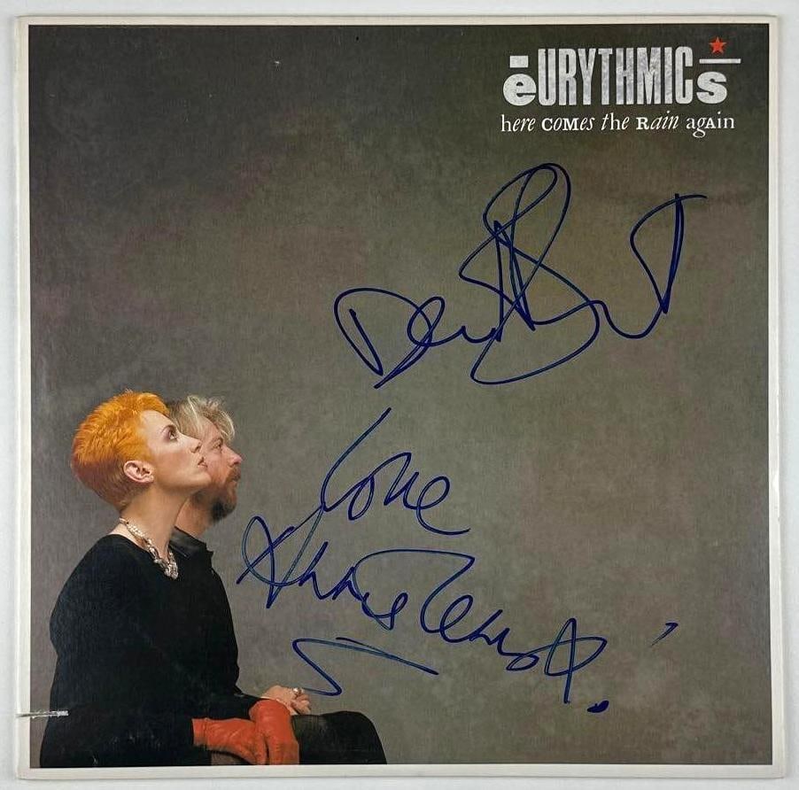Eurythmics Group Signed "Here Comes the Rain Again" Album (2 Sigs) (JSA): "Here Comes the Rain Again" album signed on the cover in blue felt tip marker by Eurythmics band members Annie Lennox and Dave Stewart. Measuring approximately 12" x 12" and in fine condition. Record