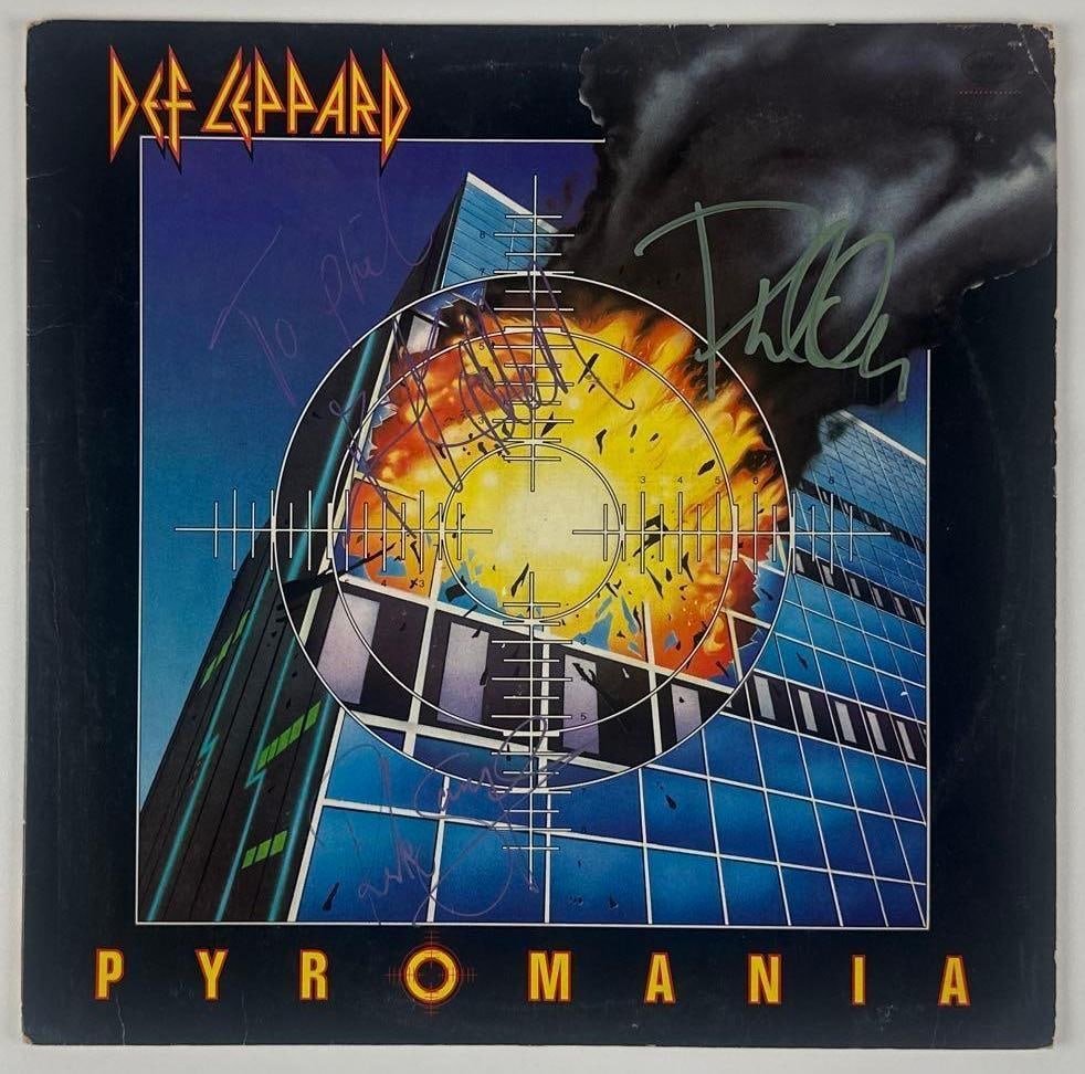 Def Leppard Multi-Signed "Pyromania" Album (3 Sigs) (JSA Authentication): "Pyromania" album signed on the cover in green and purple marker by Joe Elliott, Phil Collen, and Rick Allen of Def Leppard, with an inscription in the hand of Joe Elliott. Measuring approximately
