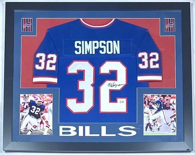 O.J. Simpson Signed Buffalo Bills NFL Jersey Framed Display (Beckett Authentication): Blue #32 Buffalo Bills NFL jersey framed display signed on the front in black felt tip marker by player O.J. Simpson. Signed jersey measures 27" x 28" and is displayed in a frame measuring 35.5" x