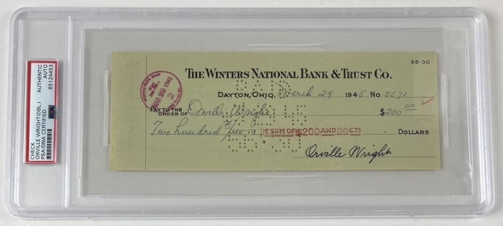 Orville Wright Twice-Signed 1945 Bank Check PSA/DNA Encapsulated: White paper 8.5" x 3" check drawn on The Winters National Bank & Trust Company, twice signed by inventor and aviation pioneer Orville Wright. Completed in black ink on May 29, 1945, the check is made 