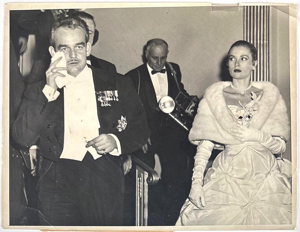 Grace Kelly & Prince Rainier III 1956 International News 11" x 14" News Service Photograph: Vintage black-and-white 11" x 14" 1956 News Service photograph of actress Grace Kelly with her fiance Prince Ranier III. This photo was taken on January 6th, 1956, showing the two leaving a ball throw
