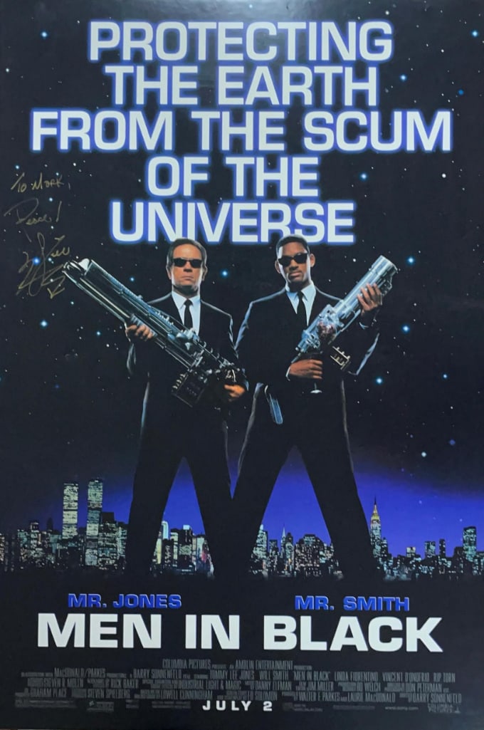 Will Smith Signed 39.75" x 26.5" "Men in Black" Foamcore Poster (Third Party Guaranteed): Color 39.75" x 26.5" foamcore poster for the film "Men in Black" signed in gold felt tip marker by actor Will Smith, who inscribed the message "To Mark, Peace!" before his signature. In very good