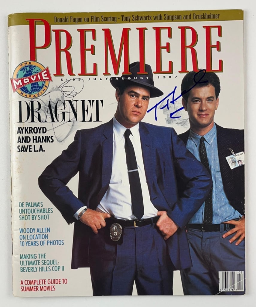 Tom Hanks & Dan Aykryod Signed Premiere Magazine (2 Sigs) (Third Party Guaranteed): Color 12" x 10" Premiere magazine signed on the cover in black and blue felt tip marker by actors Tom Hanks and Dan Aykroyd. In very good condition, with some smudging of Aykroyds' signature. Provenan