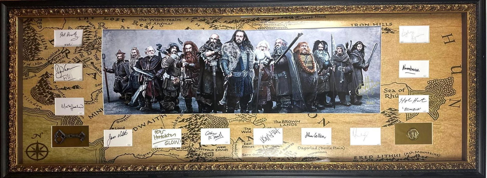 [Lord of the Rings] The Hobbit Cast Signatures in Massive Middle-Earth Display (12 Sigs) (JSA): Spectacular "The Hobbit" multi-signed cast display featuring individual signed cuts from cast members portraying Nori (Jed Brophy), Oin (John Callen), Dori (Mark Hadlow), Bain (John Bell), Gloin