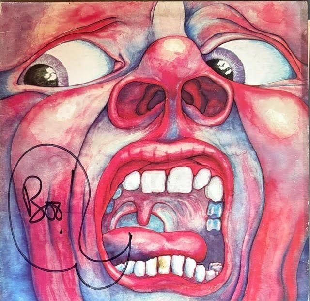 King Crimson: Robert Fripp Signed "In the Court of" Album (Third Party Guaranteed): "In the Court of the Crimson King" album signed on the inside gatefold in black marker by Robert Fripp, who also inscribed a speech bubble on the cover. Measuring approximately 12" x 12" and in good