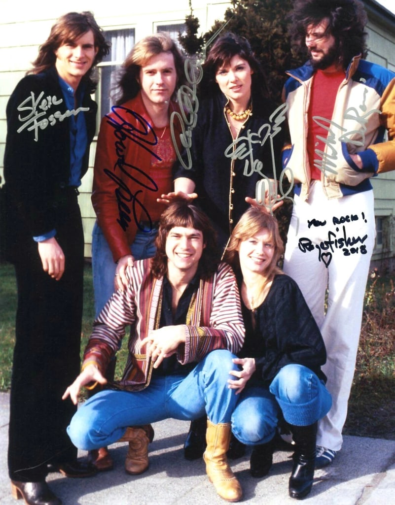 Heart Fully Group Signed 14" x 11" Photo (6 Sigs) (ACOA Authentication): Color 14" x 11" photo signed in silver and black felt tip markers by Heart band members Ann Wilson, Nancy Wilson, Howard Leese, Michael Derosier, Roger Fisher, who inscribed "You rock!" and the date