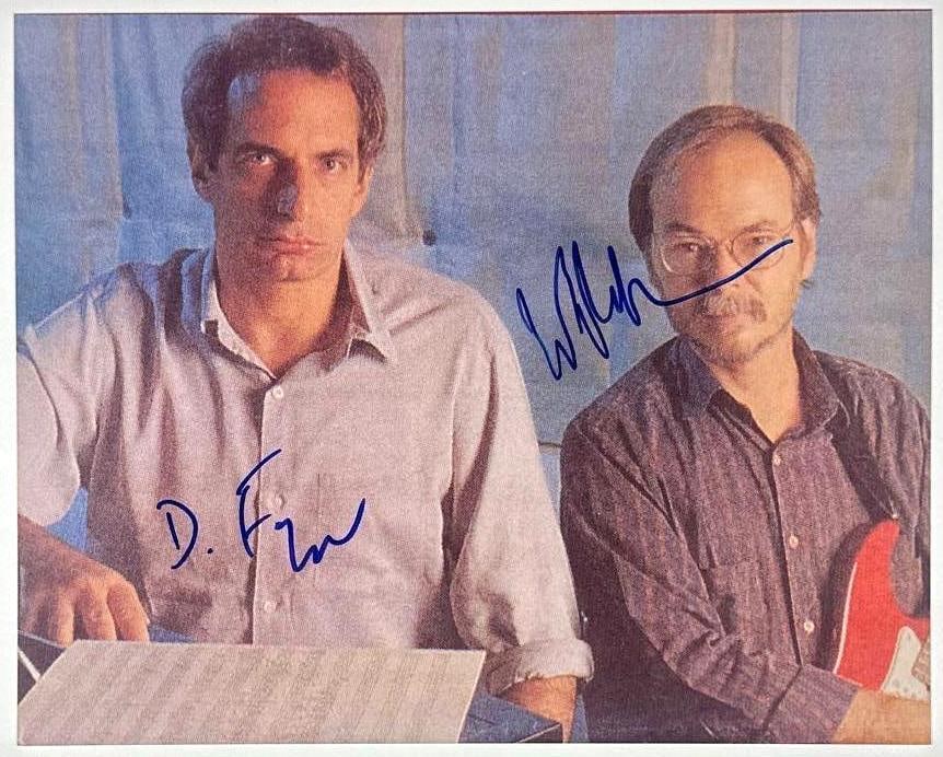 Steely Dan Group Signed 8" x 10" Photo (2 Sigs) (JSA Authentication): Color 8" x 10" photo signed in blue felt tip marker by Steely Dan band members Walter Becker and Donald Fagen. In fine condition. Provenance This piece was recently authenticated by JSA and may have