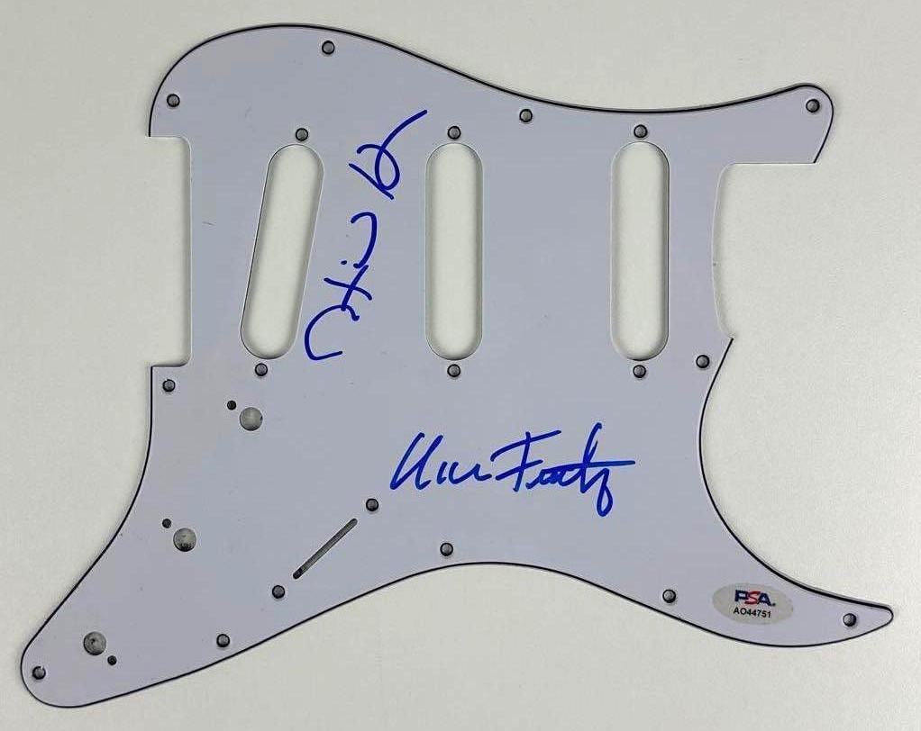 Talking Heads: Tina Weymouth & Chris Frantz Signed Pickguard (2 Sigs) (PSA/DNA): White 9" x 11" Stratocaster-style pickguard signed on the front in blue felt tip marker by Talking Heads band members Tina Weymouth and Chris Frantz. In fine condition. Authenticated by PSA/DNA, with