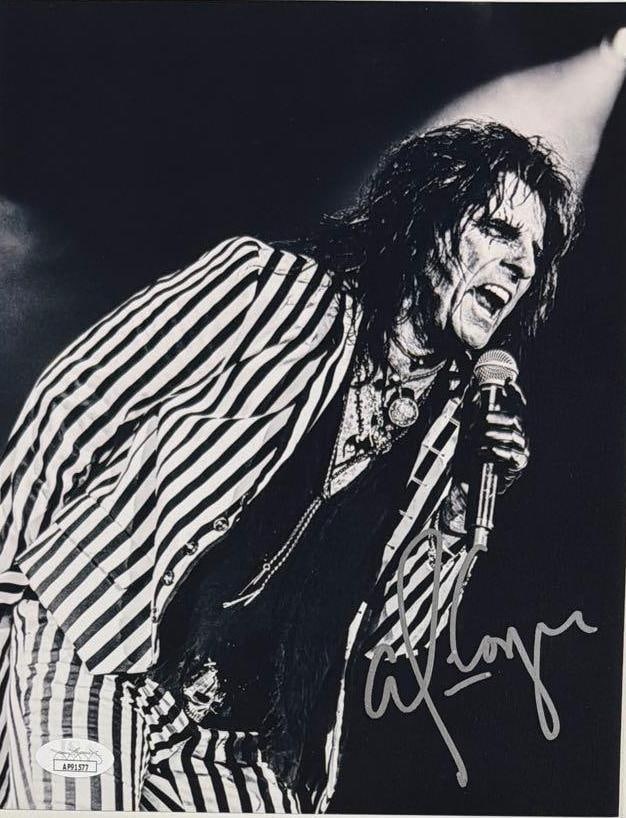 Alice Cooper Signed 10" x 8" Photo (JSA Authentication): Black-and-white 10" x 8" photo signed in silver felt tip marker by musician Alice Cooper. In fine condition. Accompanied by a JSA COA (#AP91577).