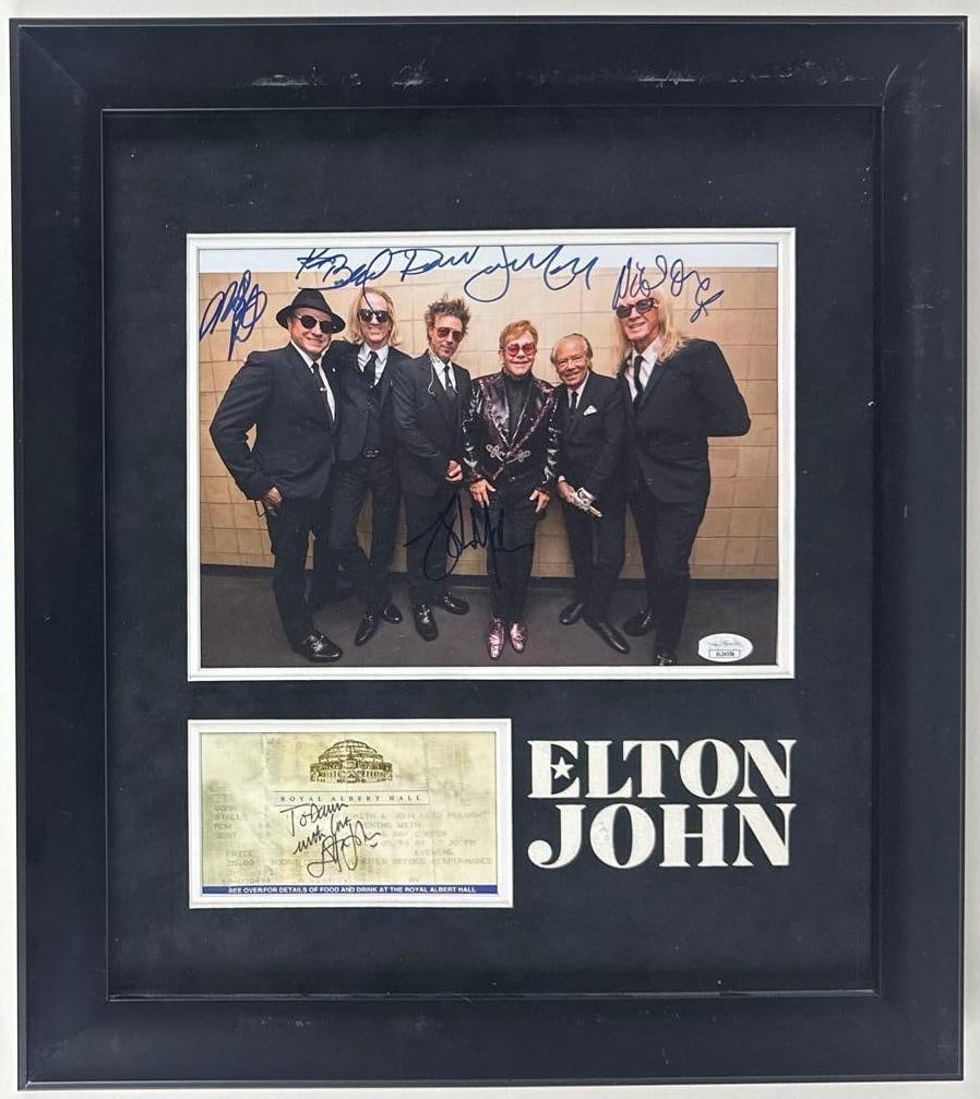 Elton John Signed "Royal Albert Hall" Ticket & Multi-Signed 8" x 10" Photo Framed Display (6 Sigs): Framed display consisting of one signed ticket, one multi-signed photo, and large white text reading "Elton John" next to the ticket. White paper 3.25" x 5.75" "Royal Albert Hall" ticket signed on