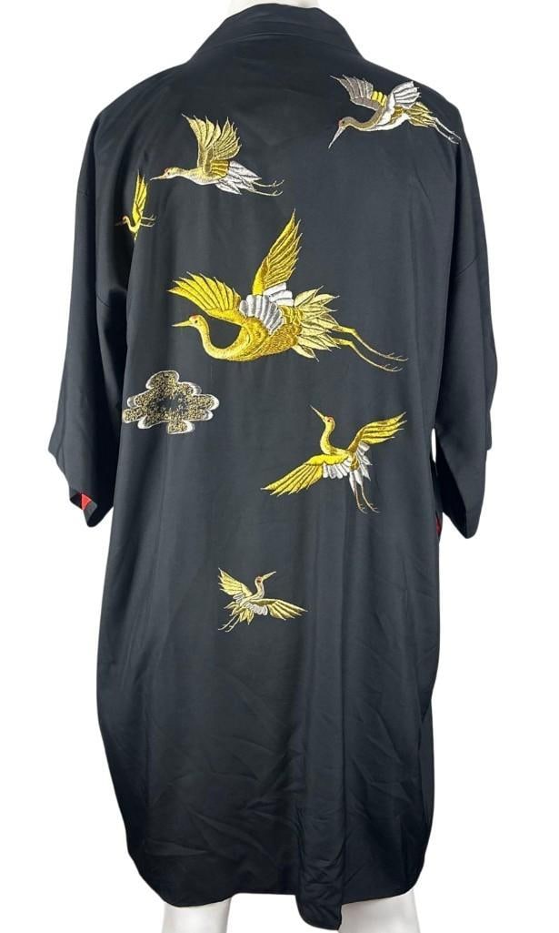 Black Embroidered Crane Kimono Robe (Chip Rachlin Collection): Black embroidered kimono robe featuring gold, silver, and white embroidered cranes across the front and back, accented by embroidered cloud motifs. The elegant crane design draws upon traditional East