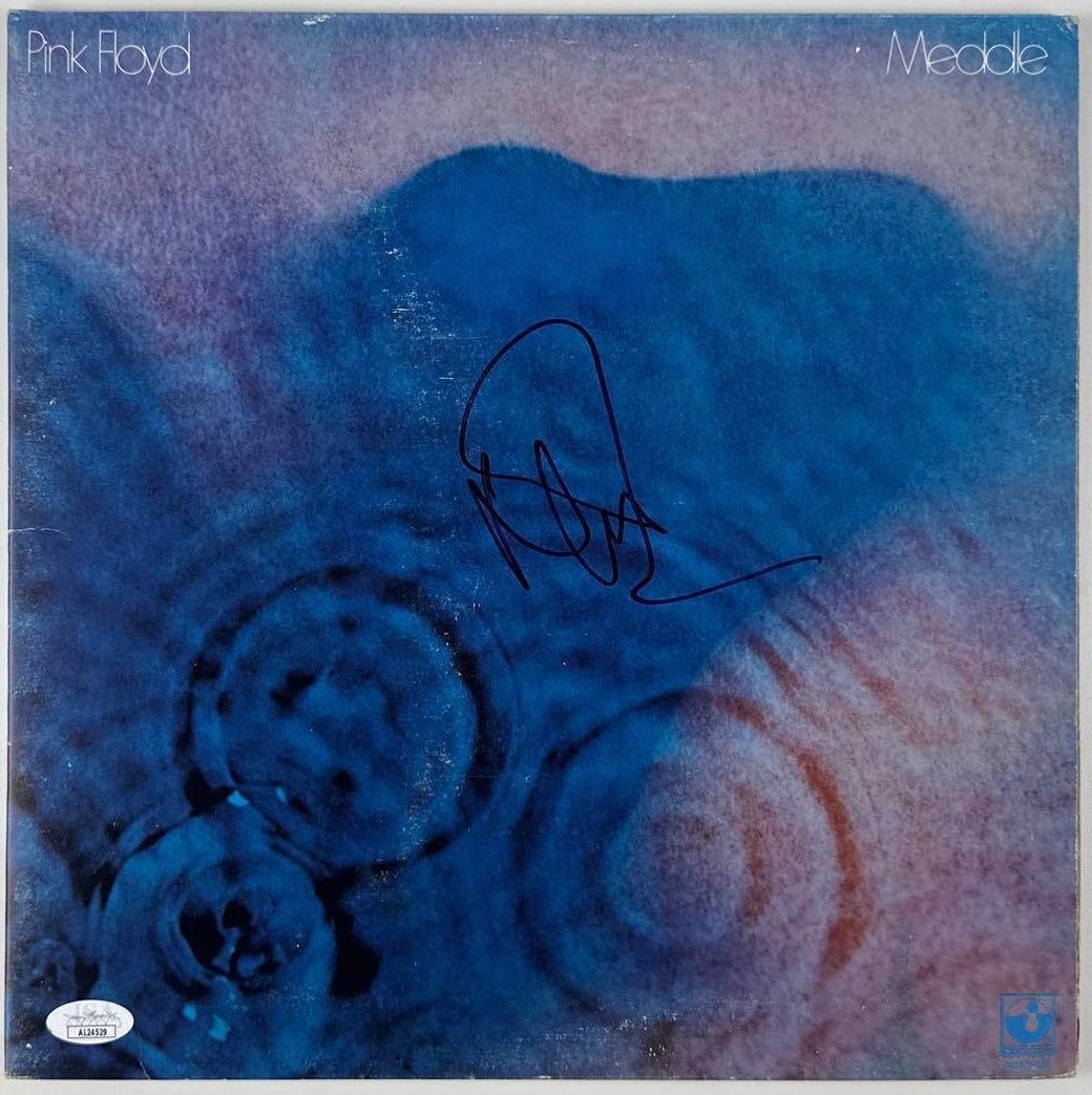 Pink Floyd: Nick Mason Signed "Meddle" Album (JSA Authentication): "Meddle" album signed on the cover in black felt tip marker by Pink Floyd band member Nick Mason. Measuring approximately 12" x 12" and in very good condition, with some signs of scattered wear.