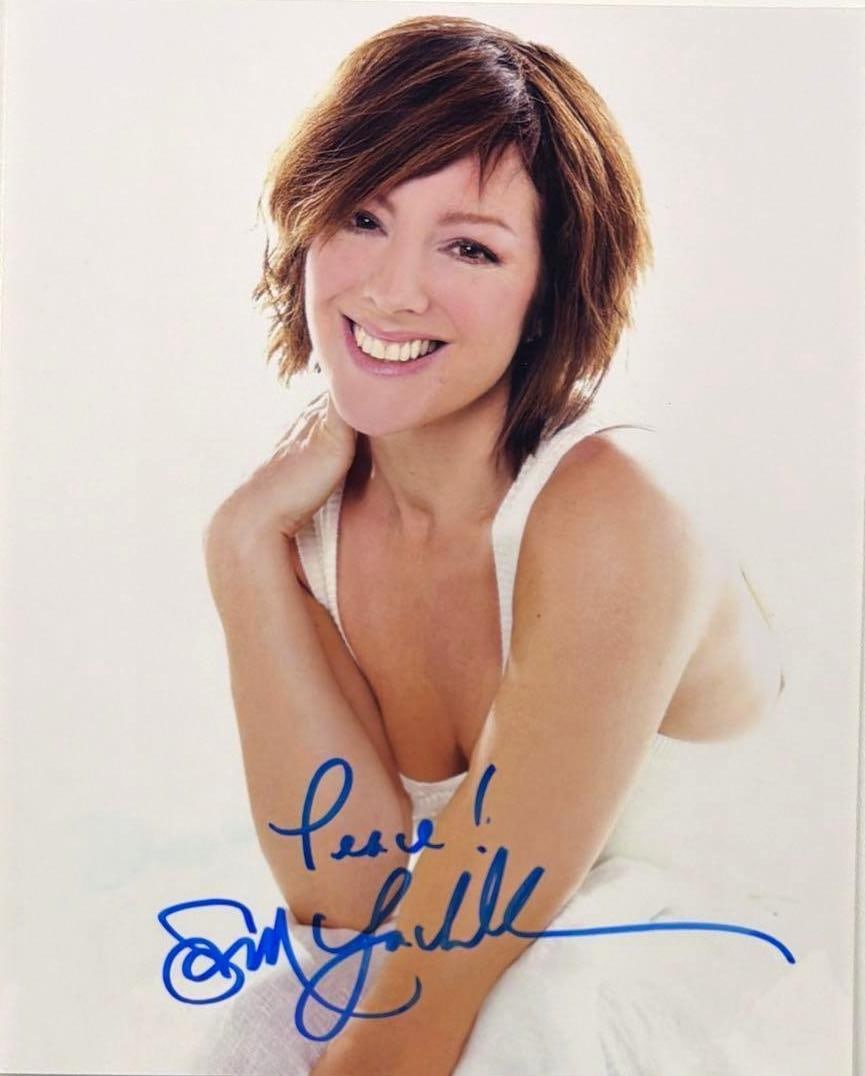 Sarah McLachlan Signed 10" x 8" Photo (Beckett Authentication): Color 10" x 8" photo signed in blue felt tip marker by musician Sarah McLachlan, who inscribed "Peace!" before her signature. In fine condition. Accompanied by a full Letter of Authenticity from