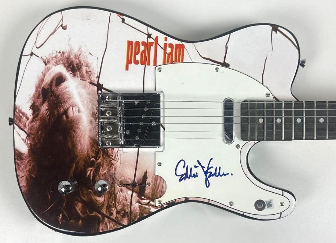 Pearl Jam: Eddie Vedder Signed "Vs." Custom Graphics Telecaster-Style Guitar (Beckett): "Vs." custom graphics Telecaster-style guitar signed on the pickguard in blue felt tip marker by Pearl Jam frontman Eddie Vedder. Measuring approximately 39" x 13" and in fine condition. Accompanied