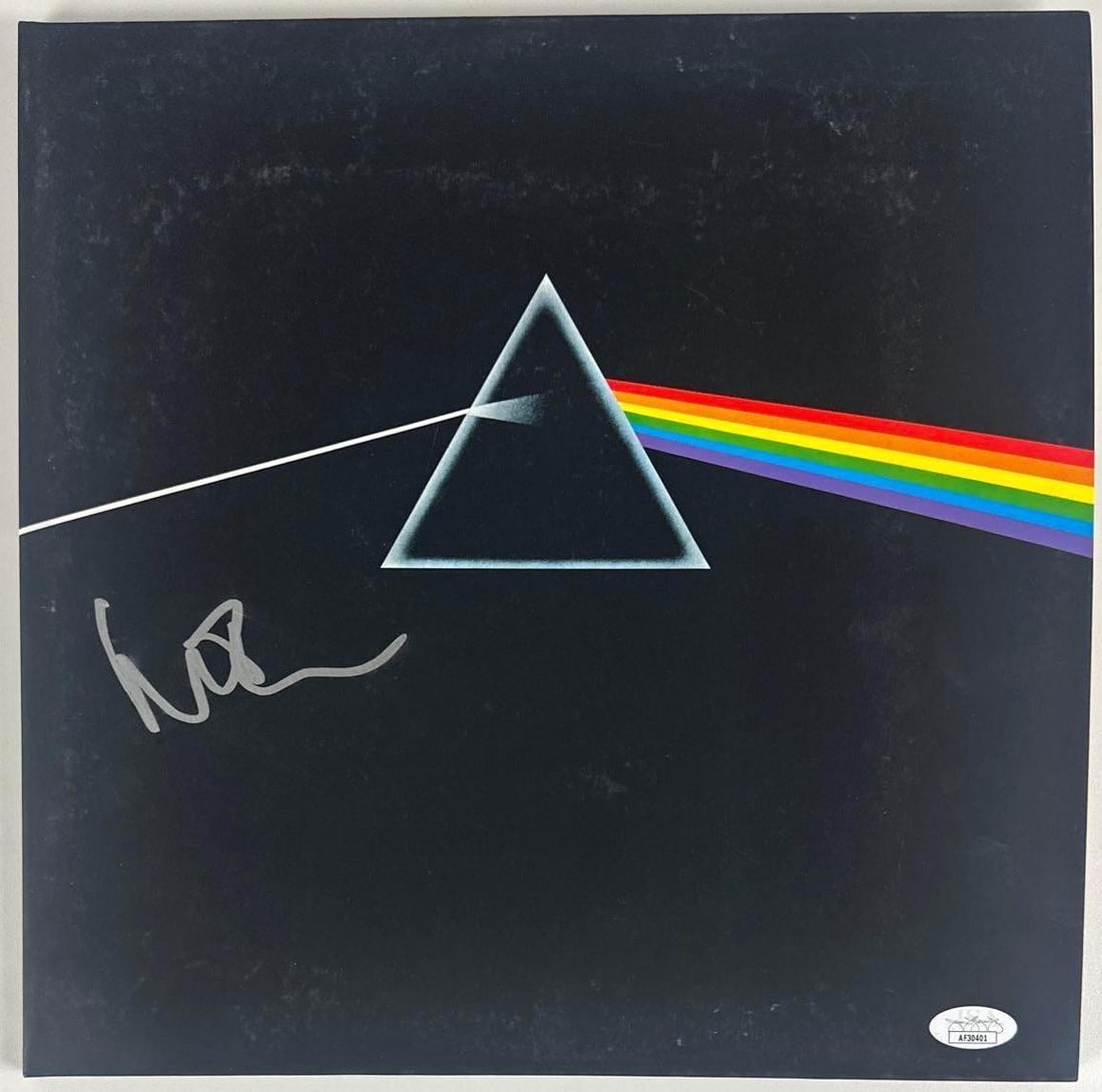 Pink Floyd: Nick Mason Signed "The Dark Side of the Moon" Album (JSA Authentication): "The Dark Side of the Moon" album signed on the cover in silver felt tip marker by Pink Floyd band member Nick Mason. Measuring approximately 12" x 12" and in fine condition. Record is included.