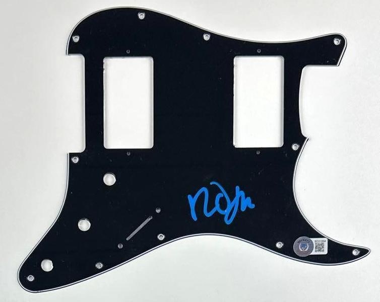The Cure: Robert Smith Signed Pickguard (Beckett Authentication): Black 8.75" x 11" pickguard signed in blue paint pen by The Cure frontman Robert Smith. In fine condition. Authenticated by Beckett, with their official hologram affixed to the front bottom right