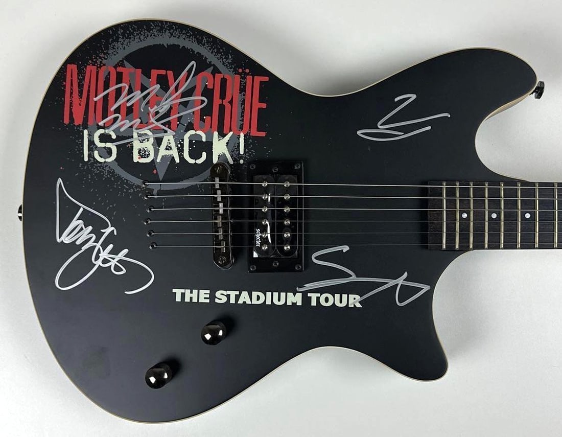 Motley Crue Group Signed "Stadium Tour" Stratocaster-Style Schecter Guitar (4 Sigs) (JSA): Black Schecter electric guitar featuring custom "Motley Crue Is Back!" and "The Stadium Tour" graphics, signed directly on the body in silver felt tip marker by all four members of Motley Crue: Vince
