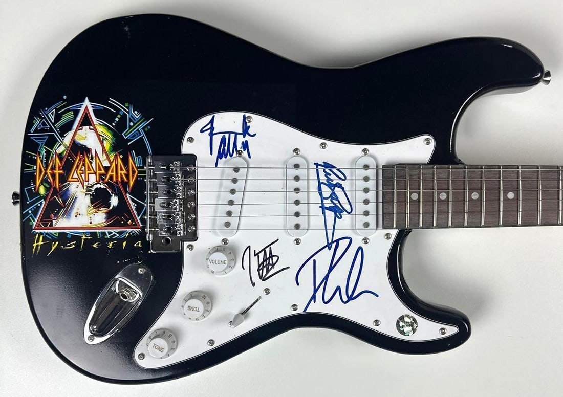Def Leppard Group Signed "Hysteria" Custom Graphics Stratocaster-Style Guitar (ACOA Authentication): "Hysteria" custom graphics Stratocaster-style electric guitar signed on the pickguard in black and blue felt tip markers by Def Leppard band members Phil Collen, Joe Elliott, Rick Savage, and Rick