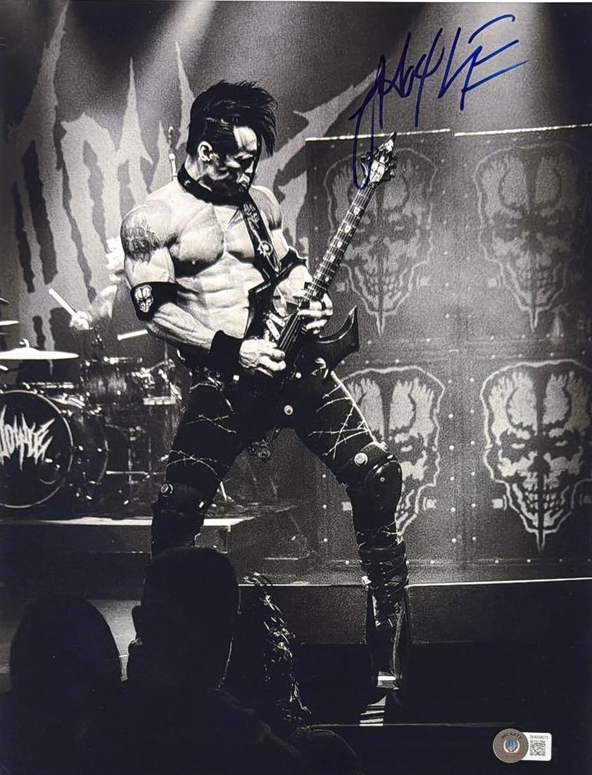 Misfits: Doyle Wolfgang Signed 14" x 11" Photo (Beckett Authentication): Black-and-white 14" x 11" photo signed in blue felt tip marker by Misfits band member Doyle Wolfgang. In very good condition, with some signs of scattered wear, including some creasing to the upper