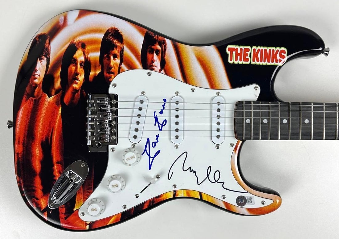 The Kinks Group Signed Custom Graphics Strat-Style Guitar (Beckett Authentication): "The Kinks Are the Village Green Presentation Society" custom graphics Stratocaster-style guitar signed on the pickguard in black and blue felt tip marker by The Kinks band members Ray and Dave
