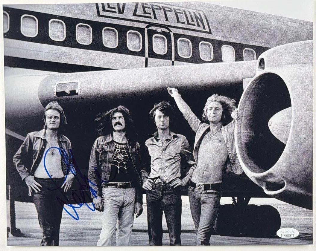 Led Zeppelin: John Paul Jones Signed 11" x 14" Photo (JSA Authentication): Black-and-white 11" x 14" photo signed in blue felt tip marker by Led Zeppelin band member John Paul Jones. In fine condition. Accompanied by a JSA COA (#AJ63328).