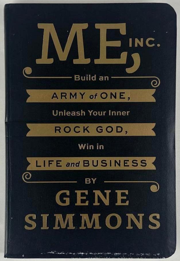 KISS: Gene Simmons Signed "Me, An Army of One" Book (JSA Authenticatino): Color hardcover 8.5" x 5.75" "Me, An Army of One" book signed on the inside front page in black ballpoint pen by Kiss band member Gene Simmons. In fine condition. Authenticated by JSA, with their offi