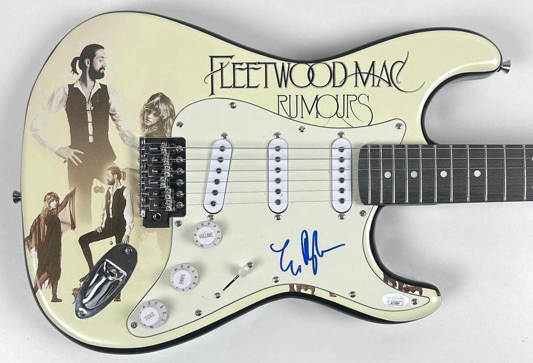 Fleetwood Mac: Lindsey Buckingham Signed "Rumors" Graphics Stratocaster-Style Guitar (JSA): "Rumors" custom graphics Stratocaster-style guitar signed on the pickguard in blue felt tip marker by Fleetwood Mac band member Lindsey Buckingham. Measuring approximately 39" x 13" and in fine