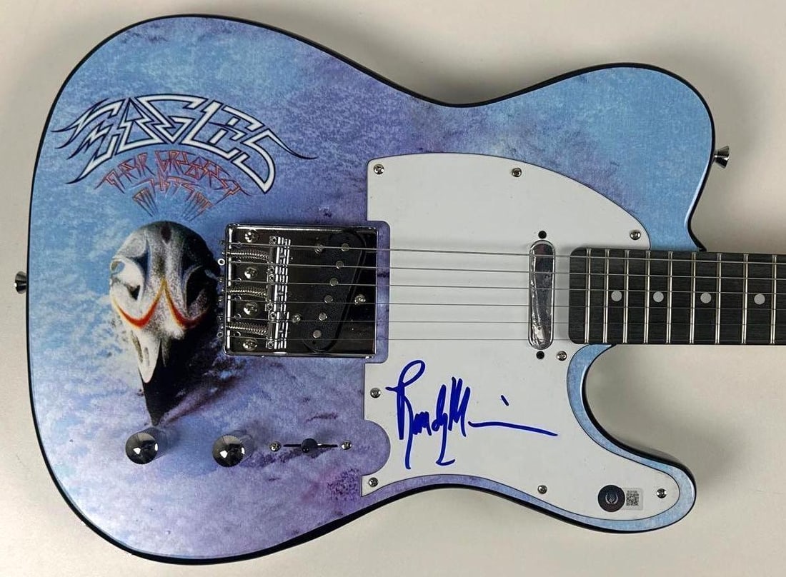 Eagles: Randy Meisner Signed "Their Greatest Hits 1971-1975" Graphics Tele-Style Guitar (BAS): "Their Greatest Hits 1971-1975" custom graphics Telecaster-style guitar signed on the pickguard in blue felt tip marker by Eagles band member Randy Meisner. Measuring approximately 38" x 17" and in fi