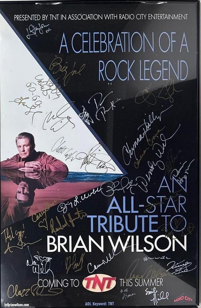 Beach Boys "Brian Wilson Tribute" Elton John, Paul Simon, Ect. Signed Poster (15+ Sigs) (Rachlin): Color framed concert poster for "An All-Star Tribute to Brian Wilson," measuring approximately 38.5" x 25.25", signed throughout in gold and silver felt tip markers by Elton John, Billy Joel, Carly Si