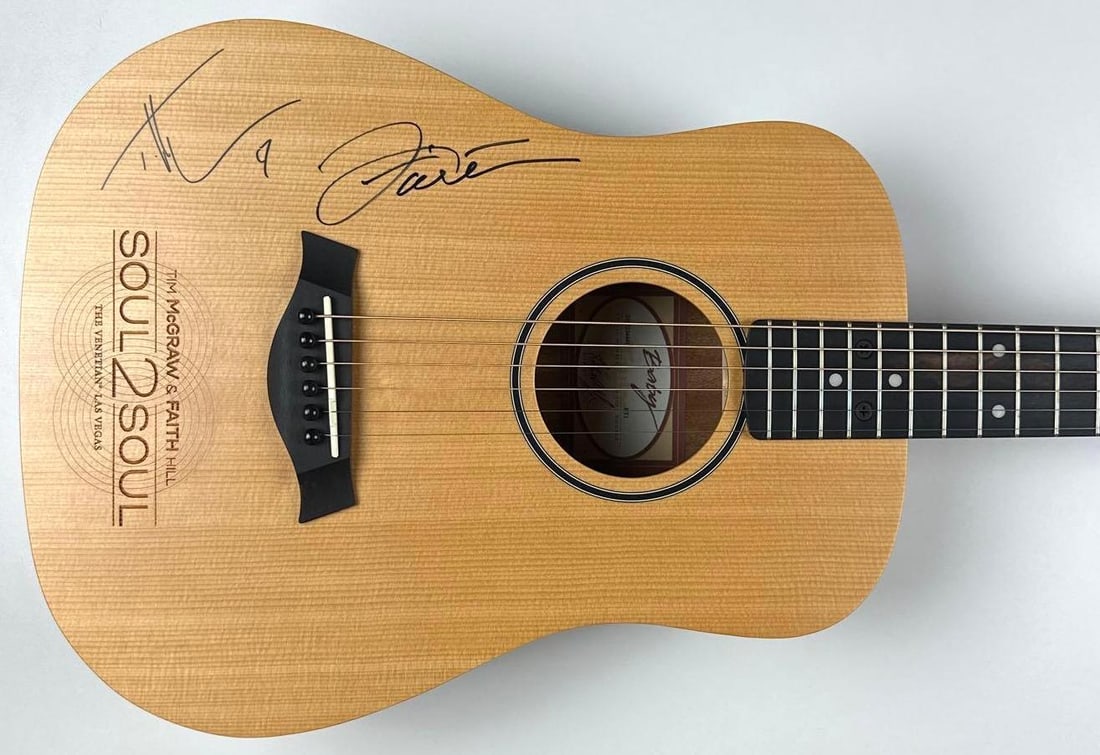 Tim McGraw & Faith Hill Signed "Soul 2 Soul" Acoustic Guitar (2 Sigs) (Tim McGraw Charity COA): Taylor Baby Taylor acoustic guitar signed on the body in black felt-tip marker by country music stars Tim McGraw and Faith Hill. The guitar features “Soul2Soul – The Venetian Las VegasR