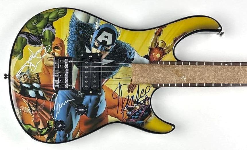 Stan Lee, Chris Evans & Mark Ruffalo Signed Avengers Peavey Rockmaster Guitar (Celebrity Authentics): Marvel Avengers custom graphics Peavey Rockmaster electric guitar, signed prominently on the body in black and silver felt-tip markers by legendary Marvel creator Stan Lee and actors Chris Evans and