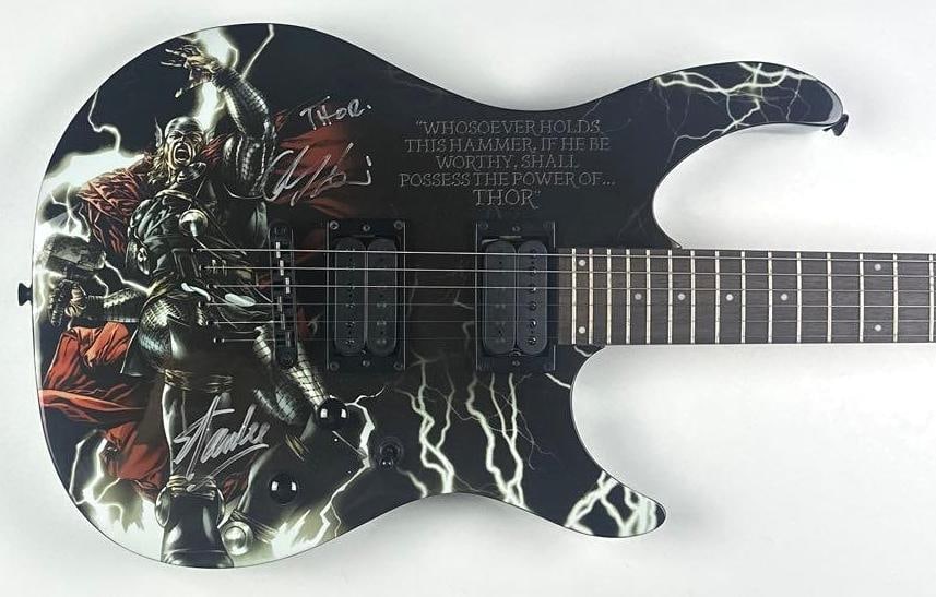Marvel Avengers: Stan Lee & Chris Hemsworth Signed Thor Peavey Predator Guitar (Official Pix): Marvel Avengers Thor custom graphics Peavey Predator electric guitar, signed on the body in silver felt-tip marker by Stan Lee and Chris Hemsworth, who additionally inscribed “Thor” with h