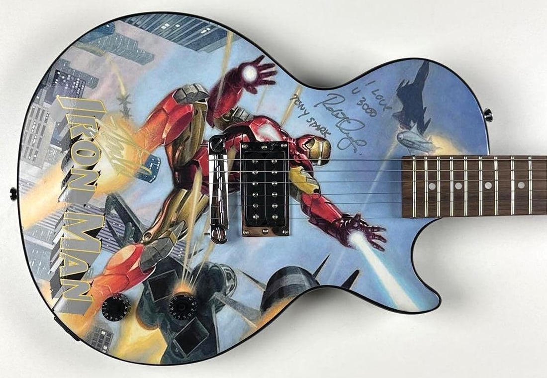Iron Man: Robert Downey Jr. & Stan Lee Signed Guitar, “I Love You 3000” (Official Pix): Marvel Iron Man custom graphics Epiphone Les Paul Junior-style electric guitar, signed prominently on the body in silver and gold felt-tip marker by Robert Downey Jr. and Stan Lee. Downey, who portray