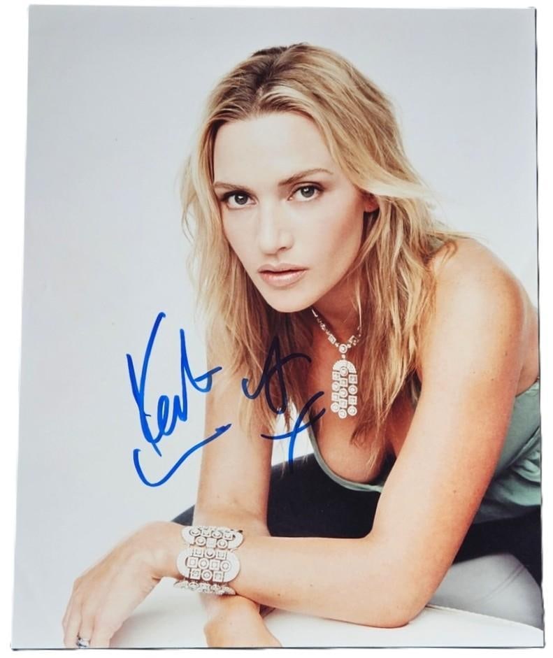 Kate Winslet Signed 10" x 8" Photo (Third Party Guaranteed): Color 10" x 8" photo signed in blue felt tip marker by actress Kate Winslet. In fine condition. Obtained in-person. Provenance Eaton & Brennan Auctions guarantees this lot to pass Third-Party