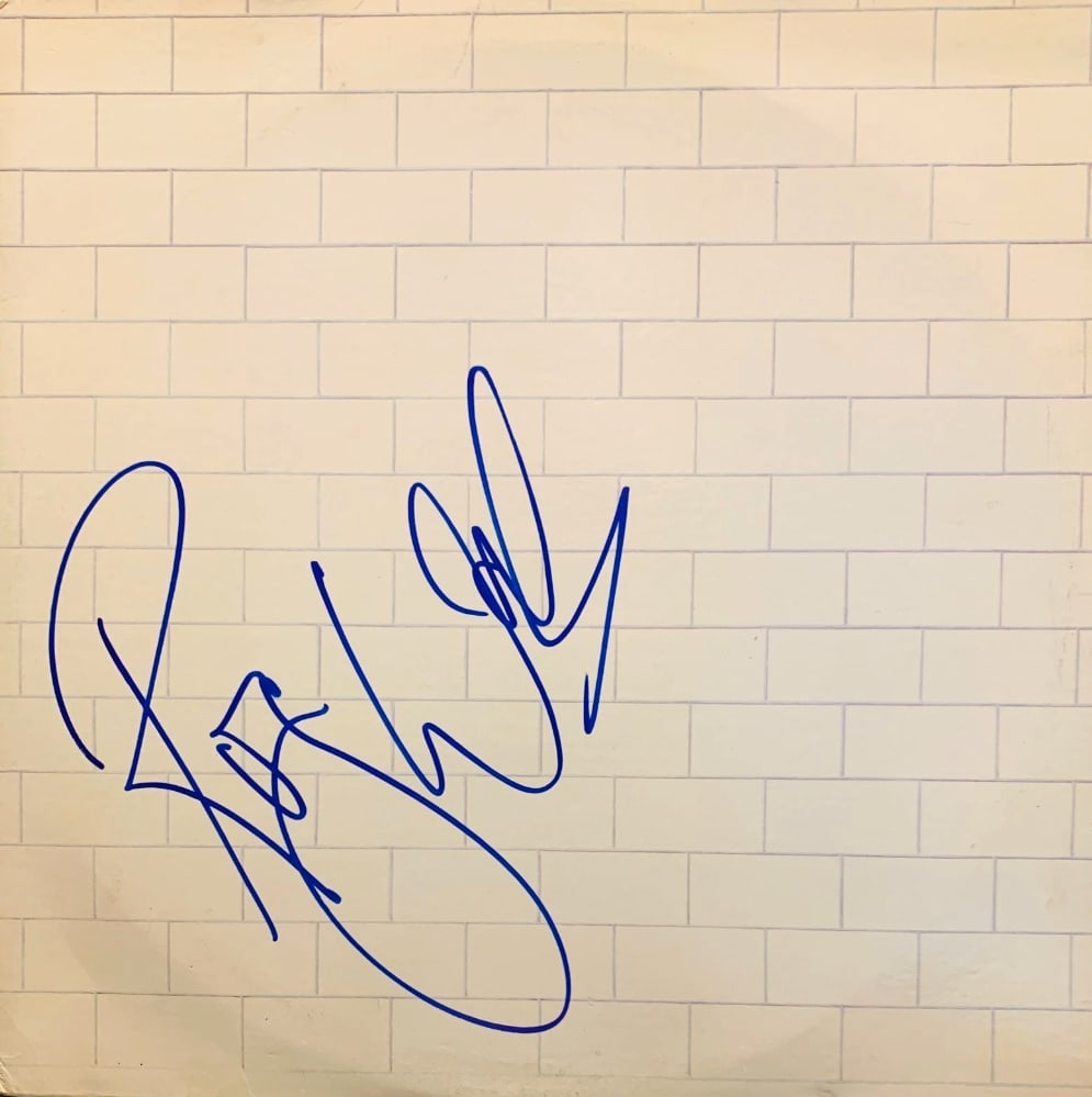 Pink Floyd: Roger Waters Signed "The Wall" Album (Beckett Authentication): "The Wall" album signed on the cover in blue felt tip marker by Pink Floyd band member Roger Waters. Measuring approximately 12" x 12" and in fine condition. Record is included. Obtained in-person.