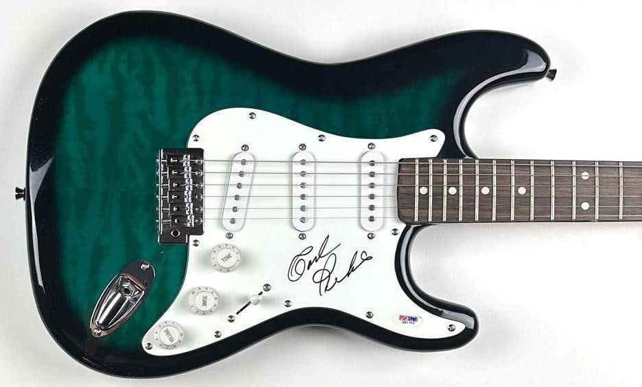 Carl Perkins Signed Stratocaster-Style Guitar (PSA/DNA Authentication): Green sunburst Stratocaster-style SX VTG Series guitar signed on the pickguard in black felt tip marker by musician Carl Perkins. Measuring approximately 40.5" x 12.75" and in fine condition. Guitar i