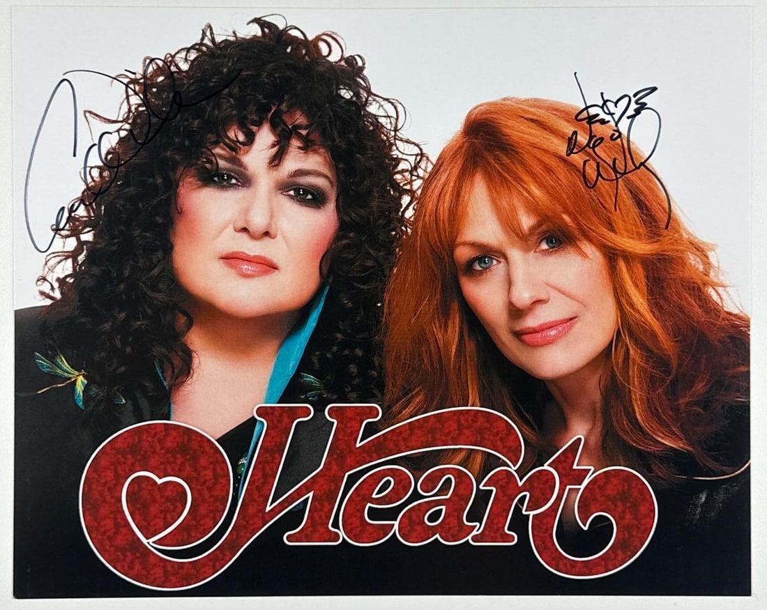 Heart: Ann & Nancy Wilson Signed 8" x 10" Photo (2 Sigs) (Third Party Guaranteed): Color 8" x 10" photo signed in black felt tip marker by Heart band members Ann and Nancy Wilson. In fine condition. Provenance Eaton & Brennan Auctions guarantees this lot to pass Third-Party