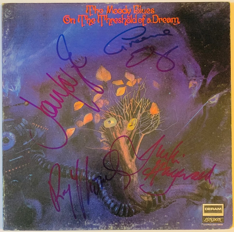 The Moody Blues Group Signed "On a Threshold of a Dream" Album (4 Sigs) (JSA Authentication): "On a Threshold of a Dream" album signed on the cover in blue felt tip marker by The Moody Blues band members Justin Hayward, John Lodge, Graeme Edge, and Ray Thomas. Measuring approximately 12" x
