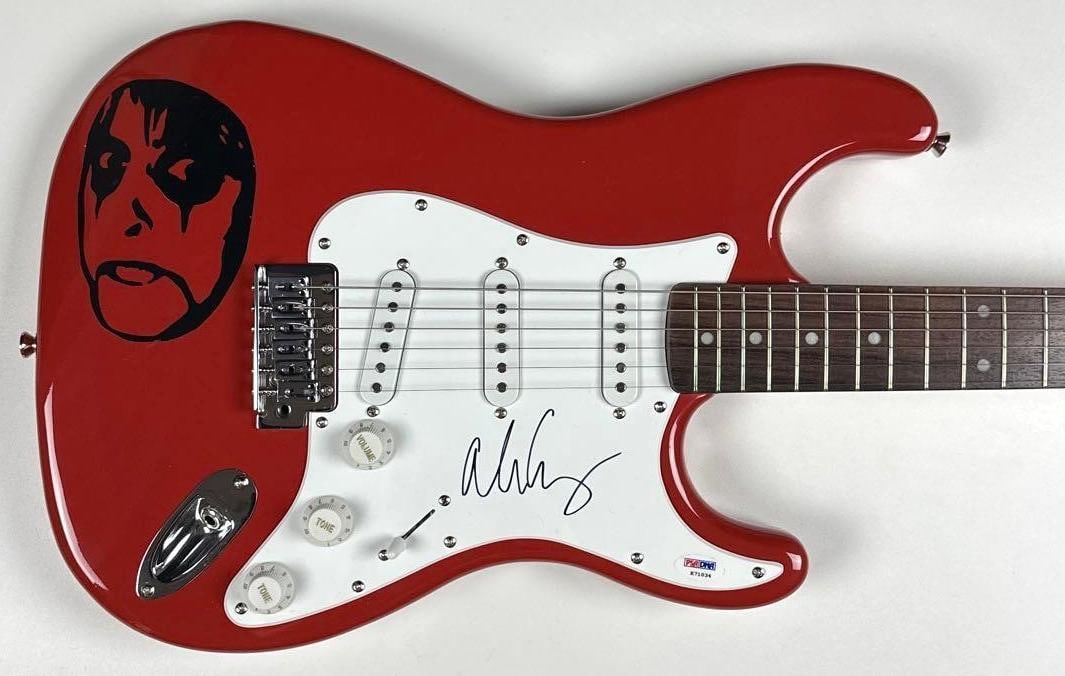 Alice Cooper Signed Custom Graphics Fender Starcaster Guitar (PSA/DNA): Red Alice Cooper custom graphics Fender Starcaster Stratocaster-style guitar signed on the pickguard in black felt tip marker by musician Alice Cooper. Measuring approximately 39.5" x 13" and in fine