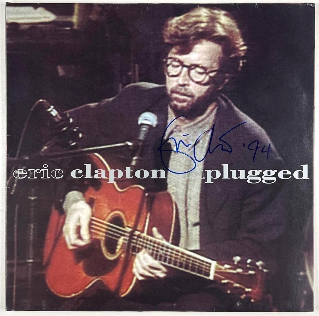 Eric Clapton Signed "Unplugged" Album (Third Party Guaranteed): "Unplugged" album signed prominently on the cover in blue felt tip marker by legendary guitarist and musician Eric Clapton, who additionally inscribed the date "94" following his signature. The dated