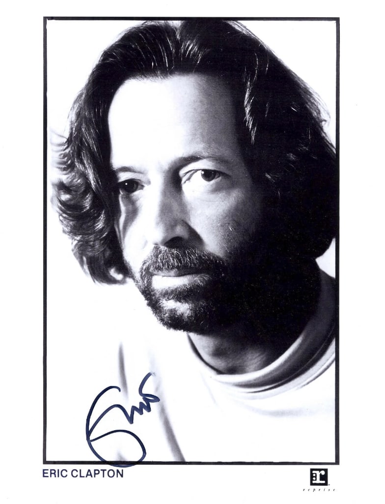 Eric Clapton Signed 10" x 8" Press Photo (ACOA Authentication): Black-and-white 10" x 8" press photo signed in black felt tip marker by musician Eric Clapton. In fine condition. Accompanied by an ACOA COA (#SA74400).
