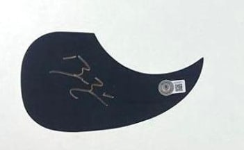 Bailey Zimmerman Signed Teardrop Pickguard (Beckett Authentication): Black teardrop shape pickguard signed in gold felt tip marker by musician Bailey Zimmerman. In fine condition. Authenticated by Beckett, with their official hologram affixed to the top of the